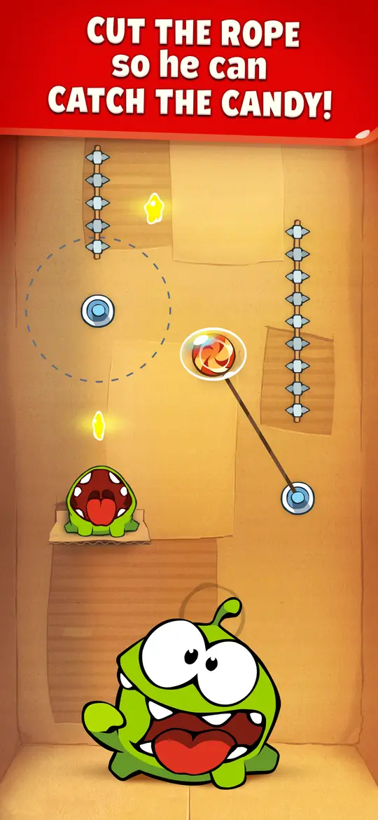 Pálya kötelekkel: a cukorka egy kötélen lóg, alatta Om Nom tátott szájjal várja, felül angol felirat – Cut the rope so he can catch the candy